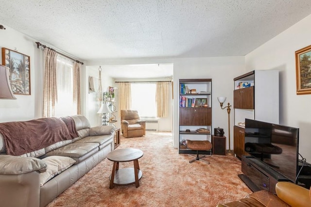 living area with a textured ceiling, radiator heating unit, and light carpet