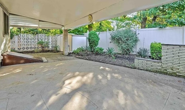 view of patio / terrace with an outdoor structure, a storage shed, and a fenced backyard