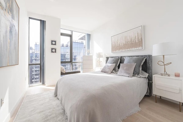 33-66 Farrington St Unit 15G, Flushing, NY 11354 - bedroom featuring light wood finished floors, baseboards, and expansive windows
