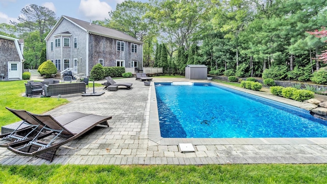 26 Boxtree Rd, East Quogue, NY 11942 - swimming pool featuring a patio, an outdoor living space, and view of scattered trees