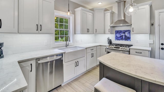 26 Boxtree Rd, East Quogue, NY 11942 - kitchen with stainless steel appliances, wall chimney exhaust hood, a sink, light stone countertops, and ornamental molding