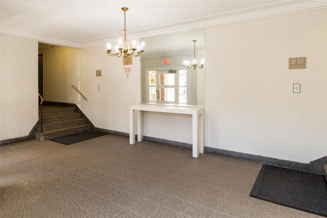 unfurnished living room featuring an inviting chandelier, crown molding, and baseboards