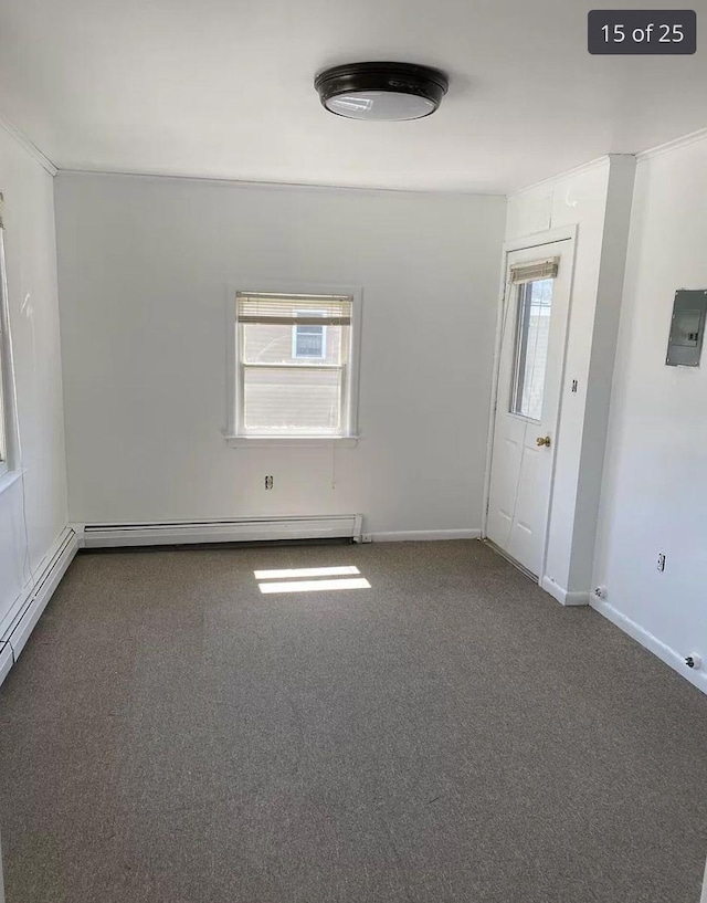 carpeted spare room featuring baseboards, a baseboard heating unit, and electric panel