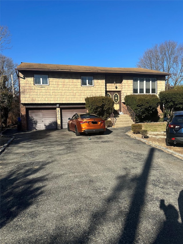 view of front of house with aphalt driveway and an attached garage