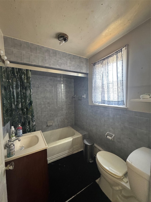 full bath with toilet, tile walls, and vanity