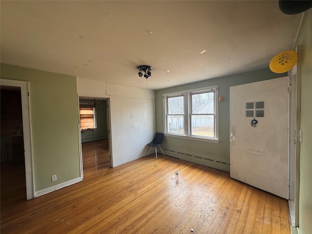 interior space with baseboard heating and light wood-style flooring