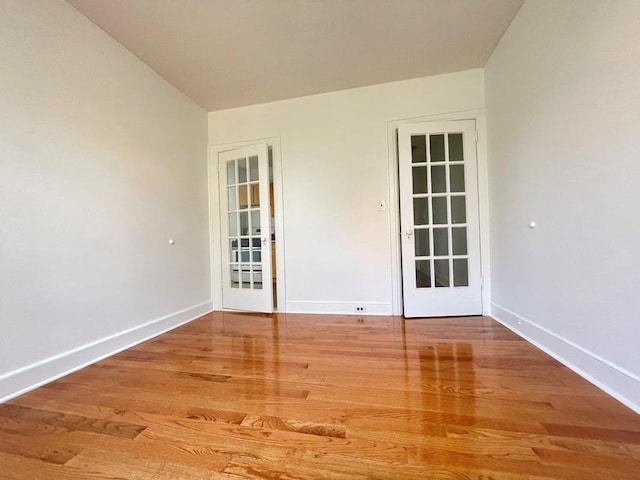 empty room featuring baseboards and wood finished floors