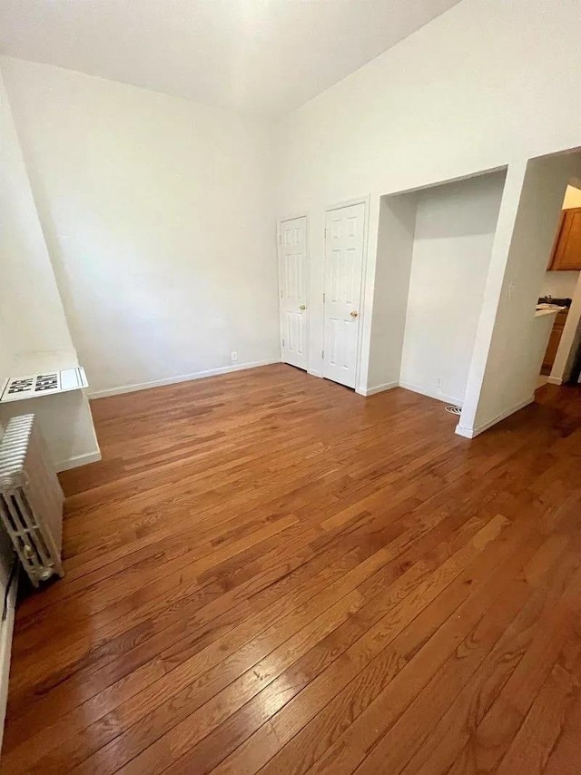 23-12 Broadway, Astoria, NY 11106 - unfurnished bedroom with baseboards and wood-type flooring