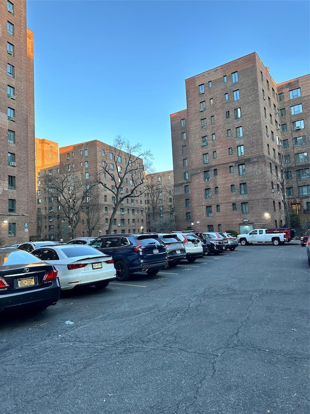 view of building exterior featuring uncovered parking