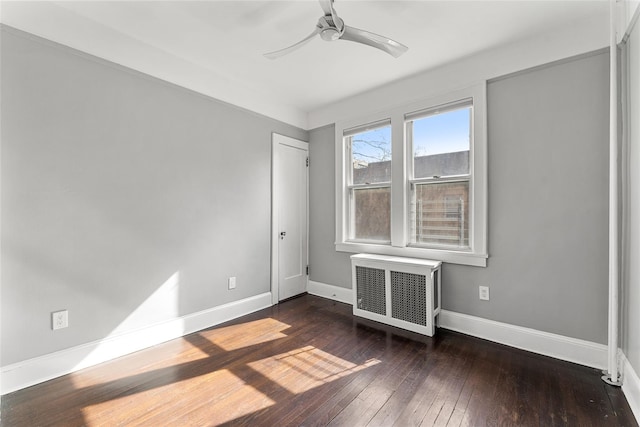 unfurnished bedroom featuring hardwood / wood-style flooring, radiator, baseboards, and ceiling fan