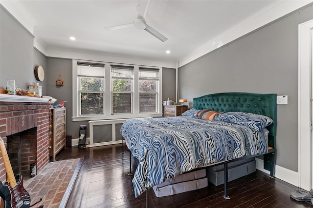 bedroom with baseboards, radiator, and hardwood / wood-style flooring