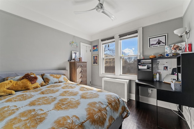 bedroom featuring hardwood / wood-style flooring, radiator heating unit, and ceiling fan