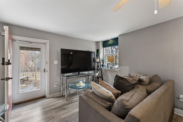 living area with wood finished floors and baseboards