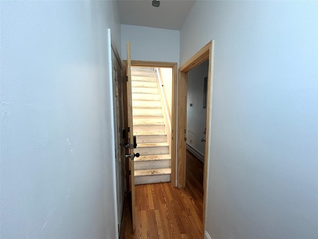 hallway featuring baseboard heating and dark wood finished floors