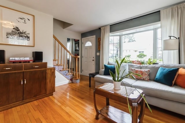 living room with stairs and light wood finished floors