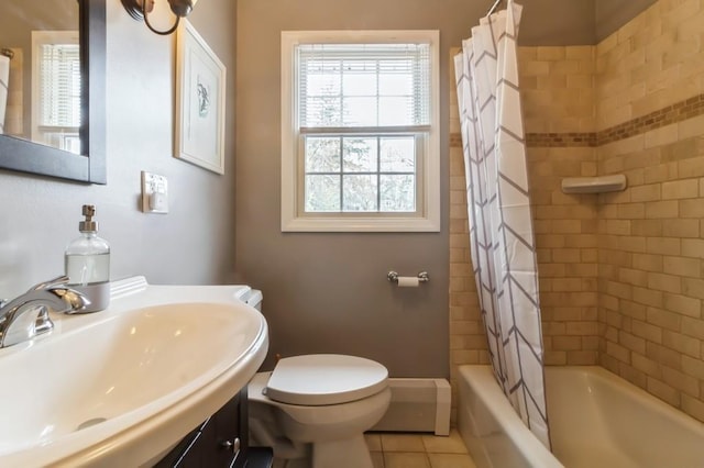 bathroom featuring a healthy amount of sunlight, tile patterned floors, shower / bath combo, and toilet