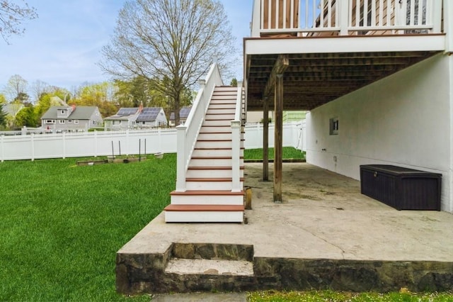 view of yard with fence, a patio, an attached carport, and stairway