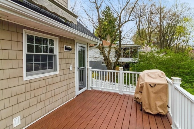wooden terrace featuring a grill