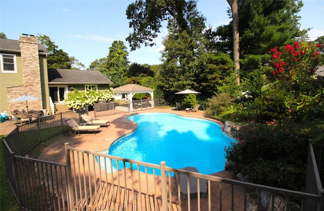 view of pool with a gazebo, fence, a fenced in pool, and a patio area