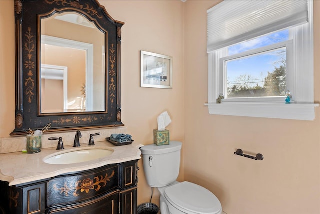 bathroom featuring toilet and vanity