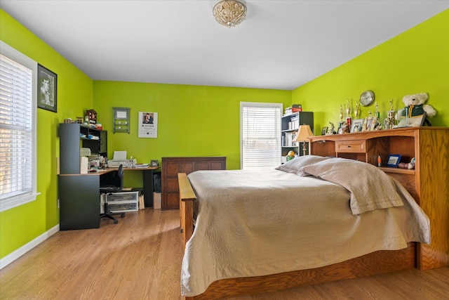 bedroom featuring baseboards and wood finished floors