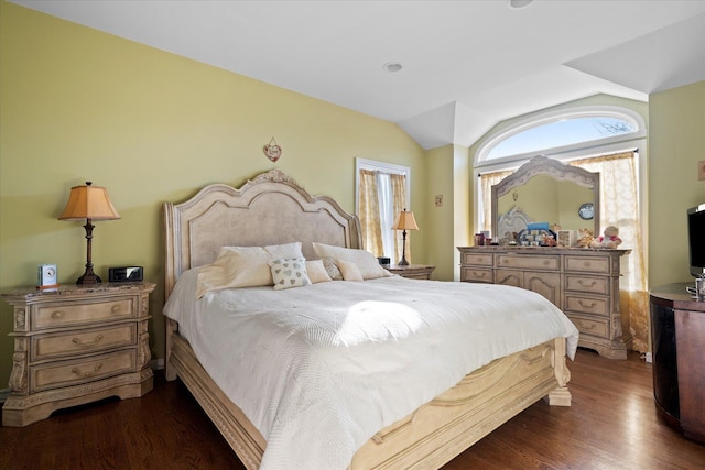 bedroom with dark wood finished floors and vaulted ceiling