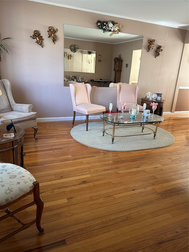 living area featuring baseboards and wood finished floors