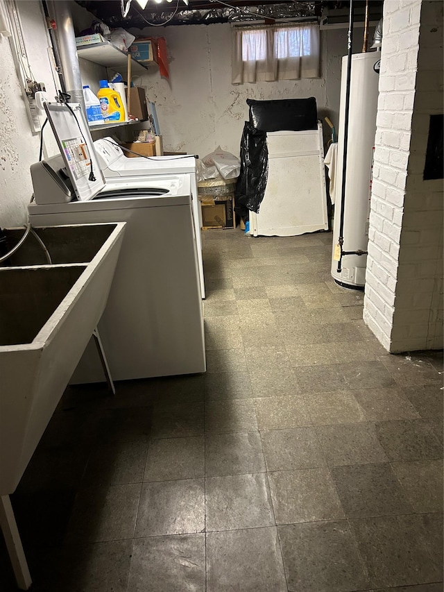 laundry area featuring gas water heater, dark floors, laundry area, and washer and clothes dryer