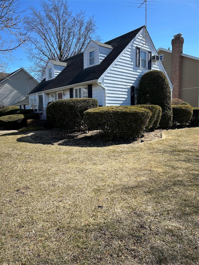 view of side of home with a yard