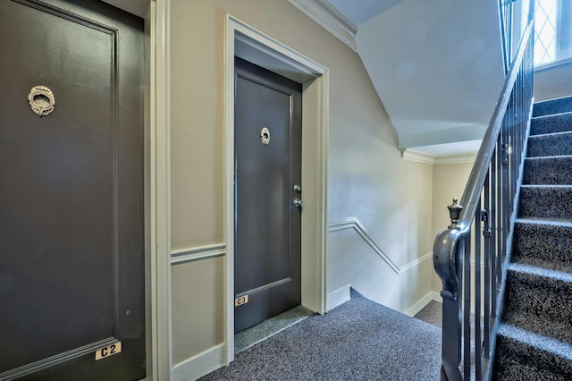 stairway with lofted ceiling, carpet, crown molding, and baseboards