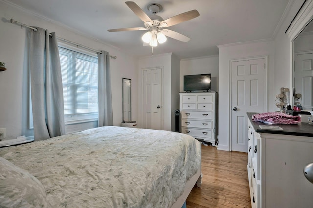 bedroom featuring a ceiling fan, wood finished floors, and crown molding