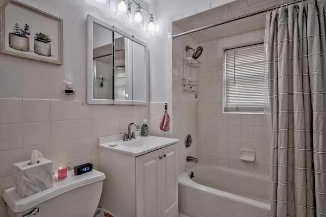 full bathroom featuring vanity, tile walls, toilet, and shower / tub combo with curtain