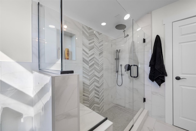 full bath featuring marble finish floor and a shower stall