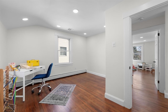 office space featuring a baseboard heating unit, plenty of natural light, wood finished floors, and baseboards