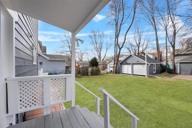 view of yard featuring an outbuilding, a garage, and fence