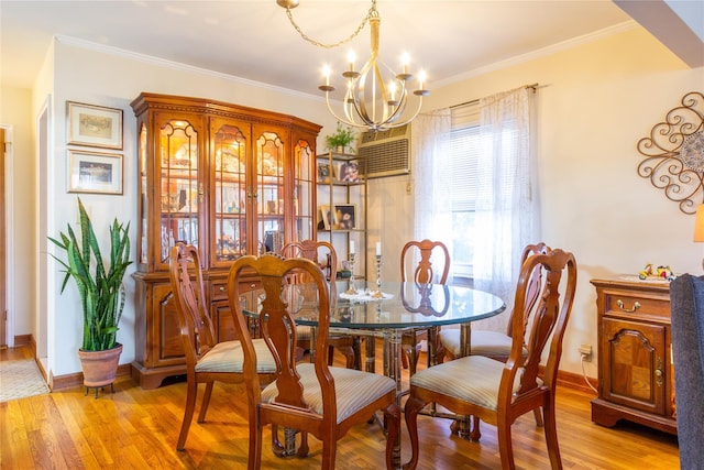 dining space with a notable chandelier, baseboards, light wood finished floors, and ornamental molding