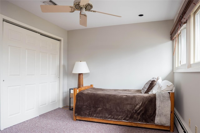 carpeted bedroom with baseboard heating, ceiling fan, and visible vents