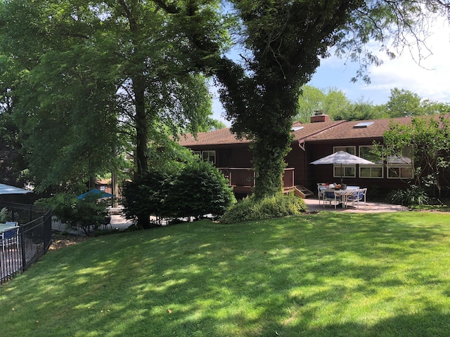 view of yard with a patio area, a deck, and fence