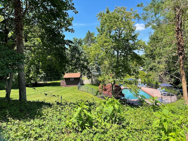 view of yard with a community pool and fence