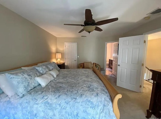 carpeted bedroom featuring visible vents and a ceiling fan