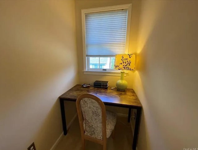 home office featuring baseboards and built in desk