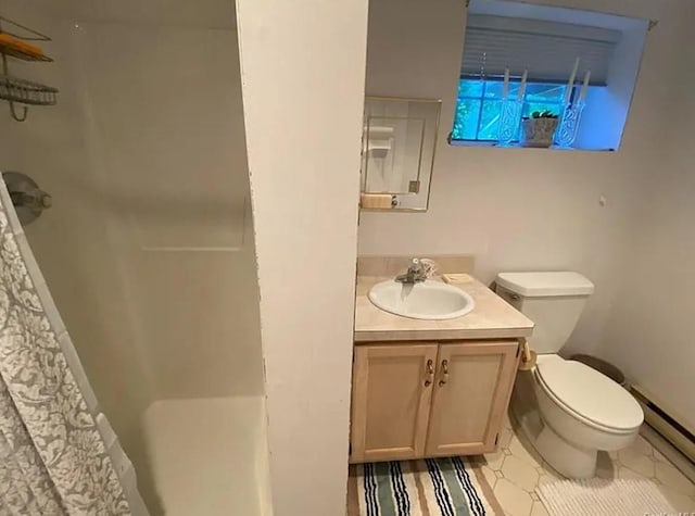 bathroom featuring vanity, curtained shower, toilet, and a baseboard heating unit