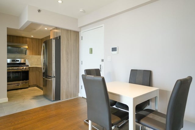 dining area with recessed lighting and light wood finished floors