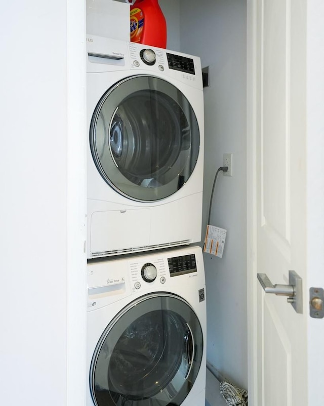 laundry room with stacked washer / dryer and laundry area