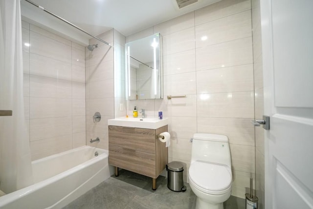 full bath featuring visible vents, toilet, shower / tub combination, tile walls, and vanity