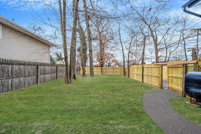 view of yard featuring a fenced backyard and heating fuel