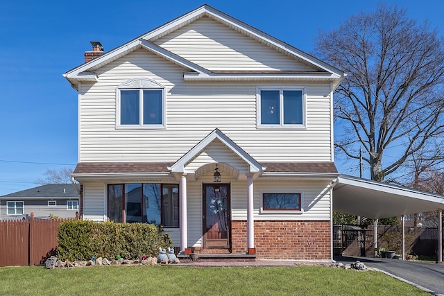 view of front of house featuring a chimney, driveway, fence, an attached carport, and brick siding