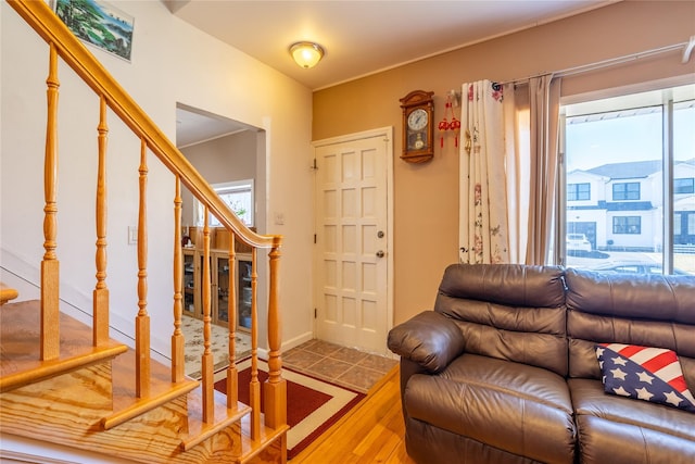 living area with stairway and wood finished floors