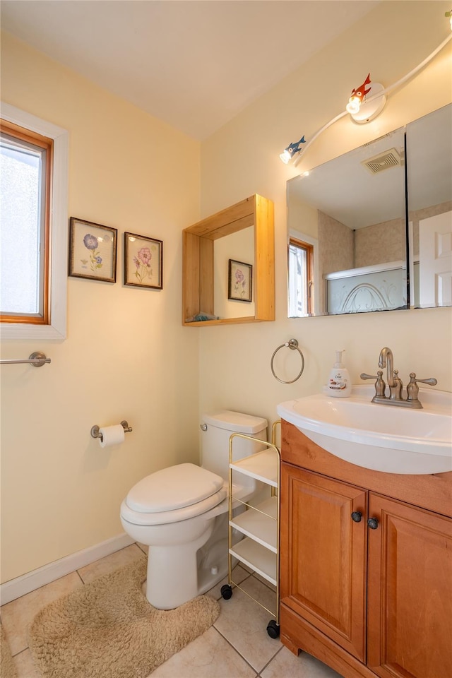 bathroom with tile patterned flooring, visible vents, baseboards, toilet, and vanity