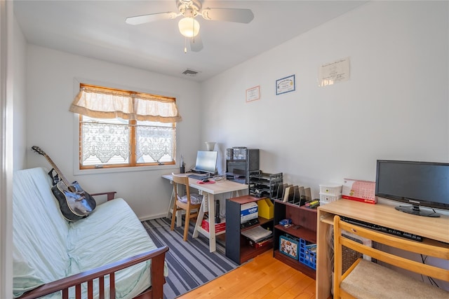 office with visible vents, wood finished floors, and a ceiling fan